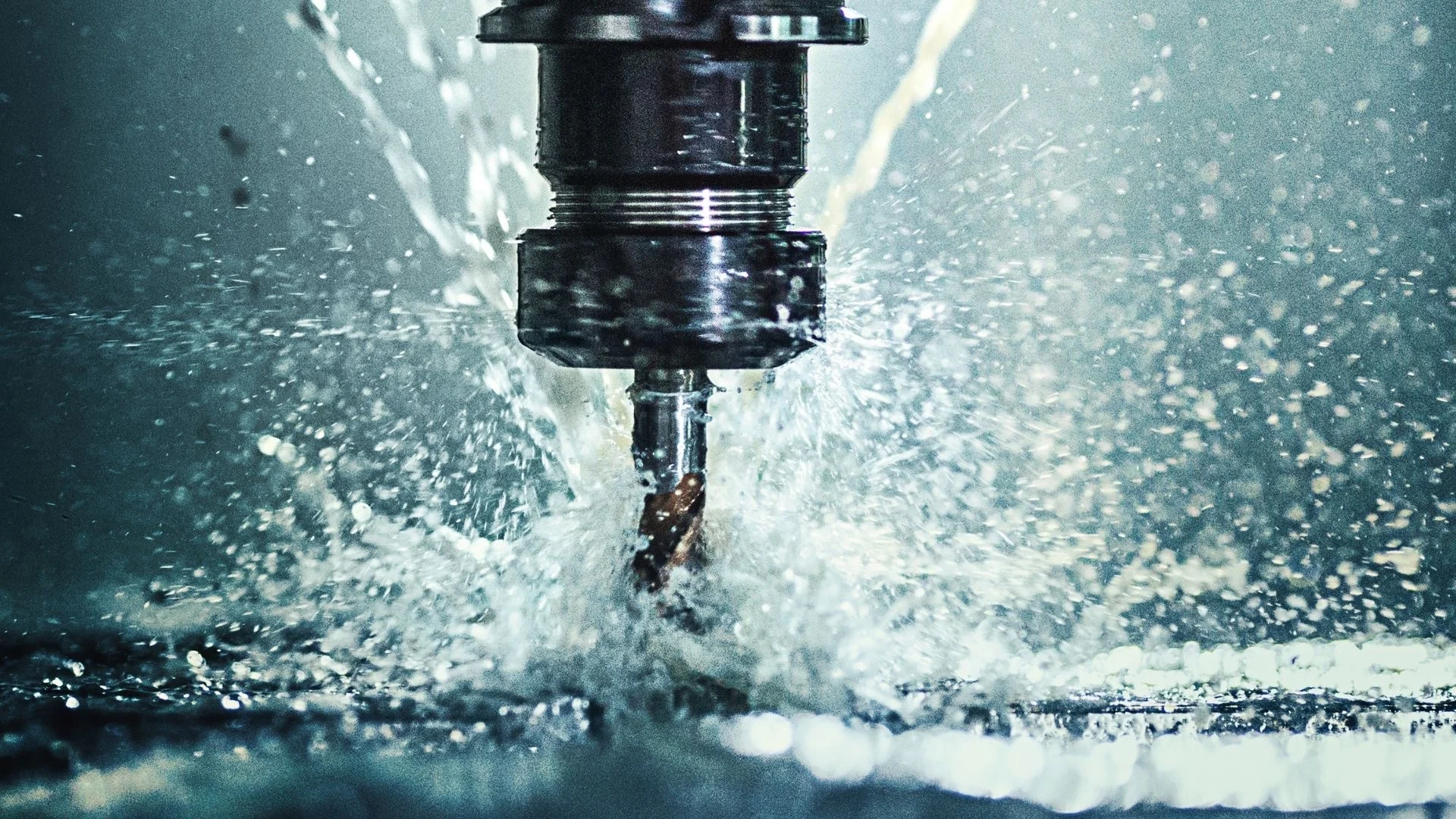 CNC machining of a metallic boss component with coolant spray during precision cutting